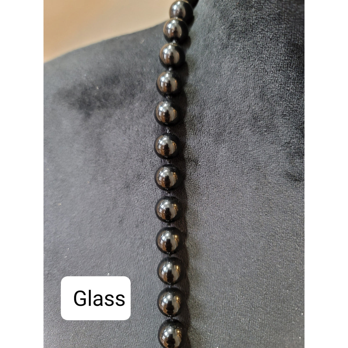 Women's Black Bead Necklace with Gold Sunburst Pendant and Elegant Design