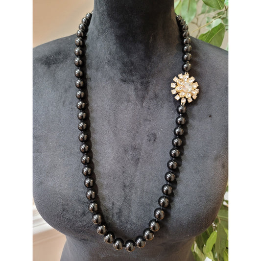 Women's Black Bead Necklace with Gold Sunburst Pendant and Elegant Design